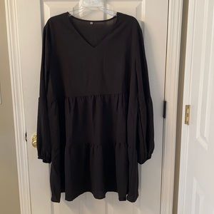 Black swing dress with balloon sleeves.